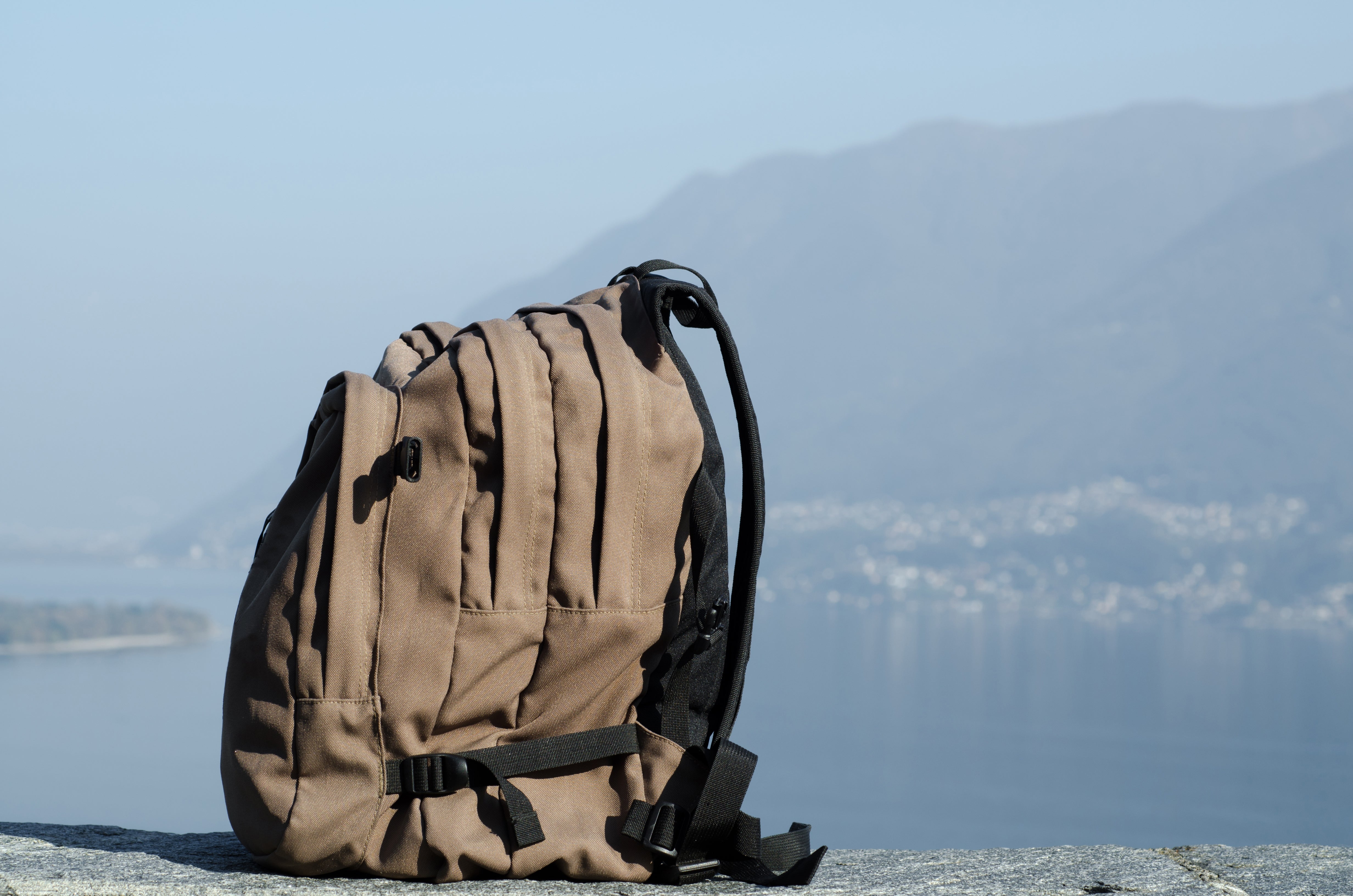 big-hiking-backpack-with-blurry-mountains-background.jpg